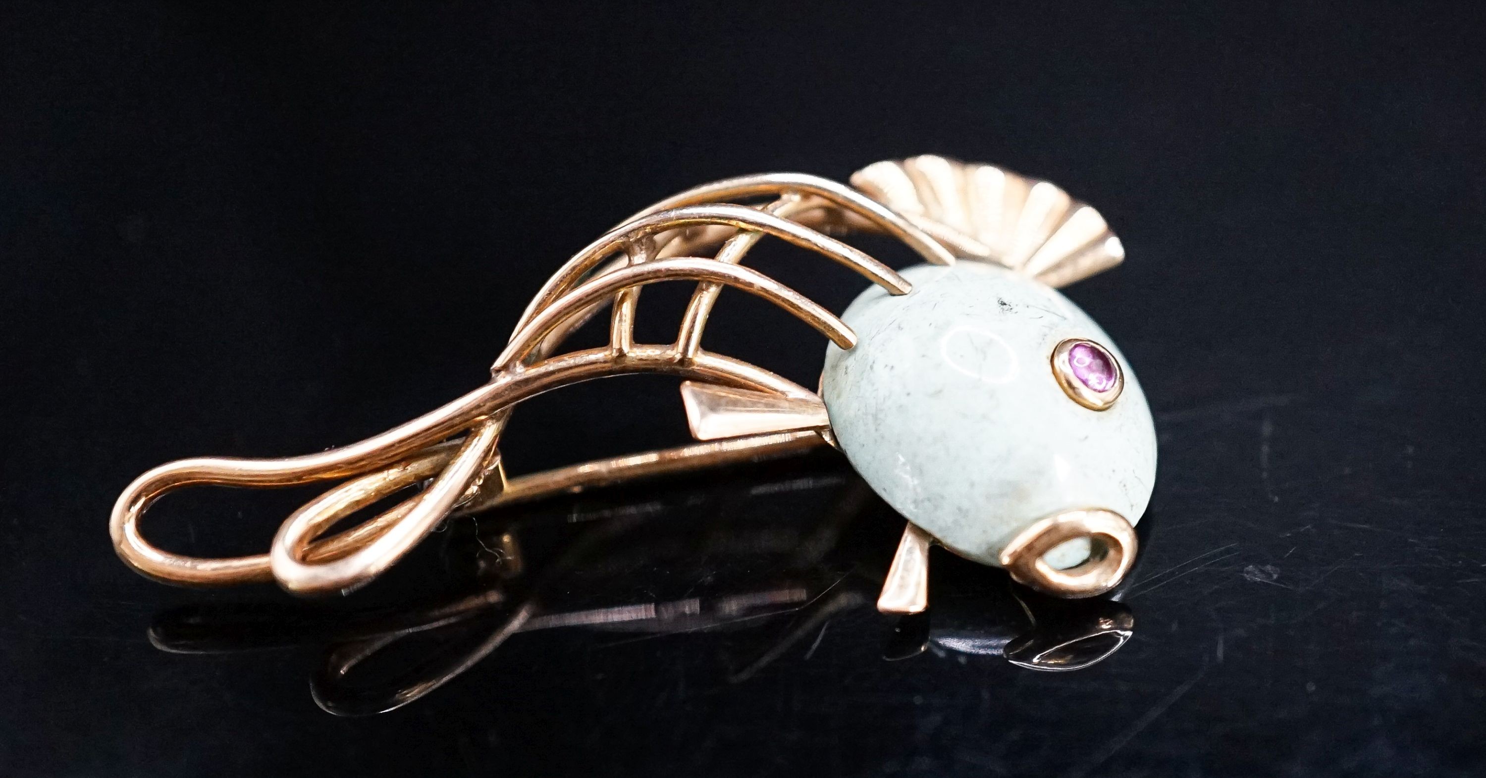 A Viennese 585 yellow metal, hardstone and cabochon ruby set brooch, modelled as a stylised fish, 39mm, gross weight 5.4 grams.
